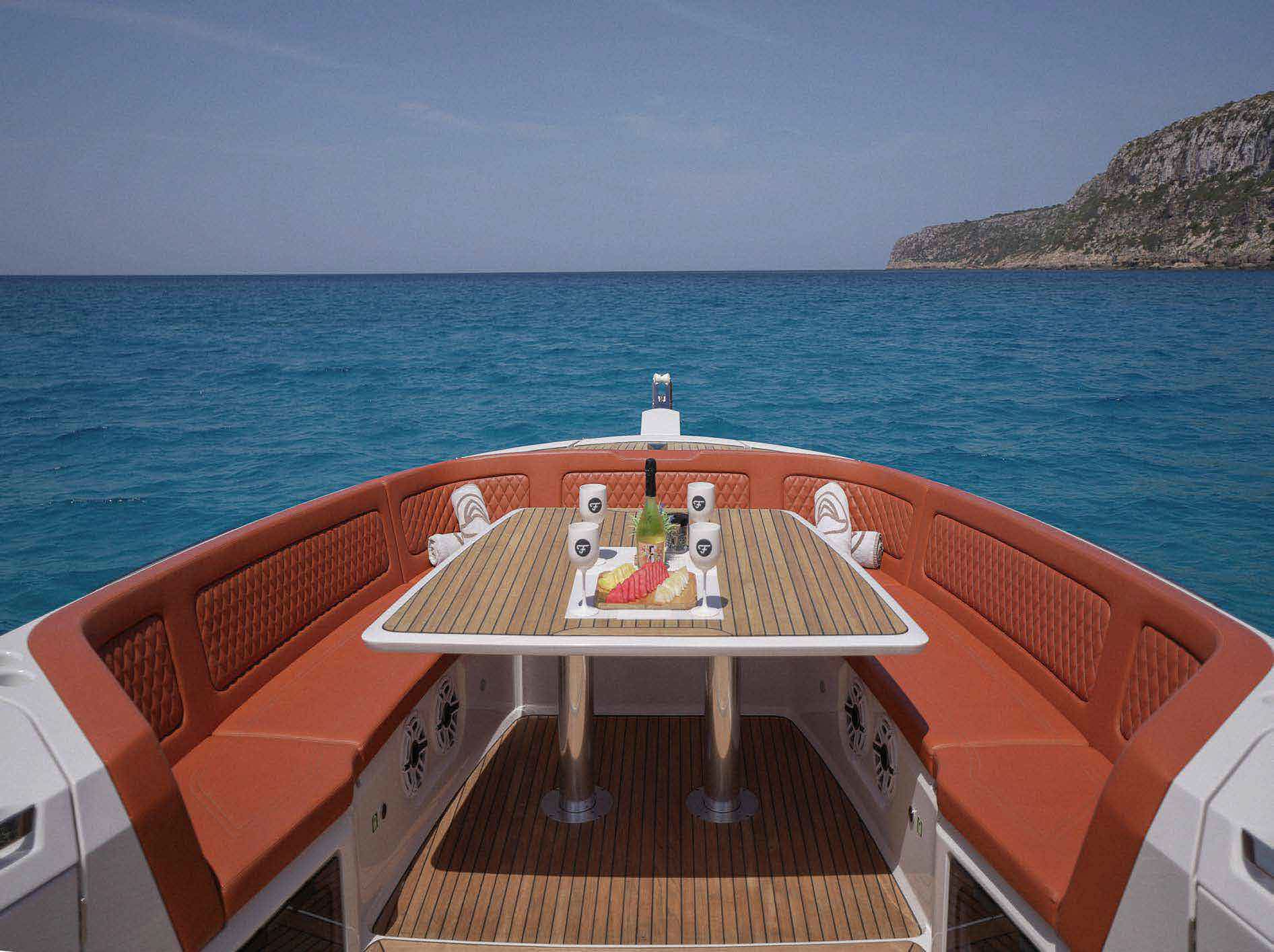 The bow of a Frauscher 40 set for lunch, looking out toward the Formentera coast.